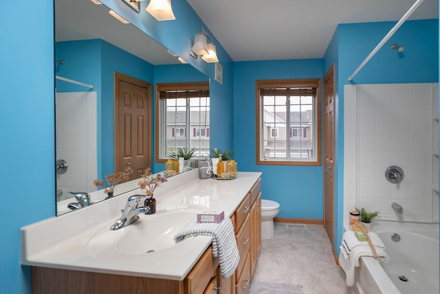 bathroom featuring vanity, toilet, baseboards, tile patterned flooring, and  shower combination