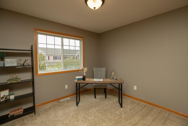 carpeted office featuring visible vents and baseboards