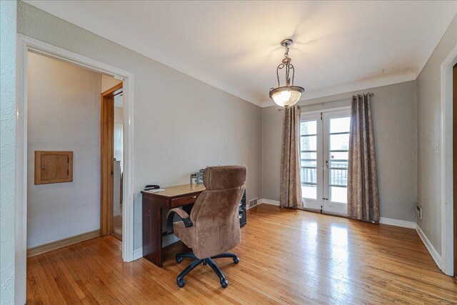 office area with baseboards, french doors, light wood finished floors, and visible vents