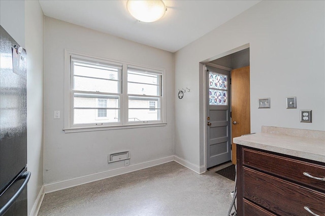 doorway featuring baseboards