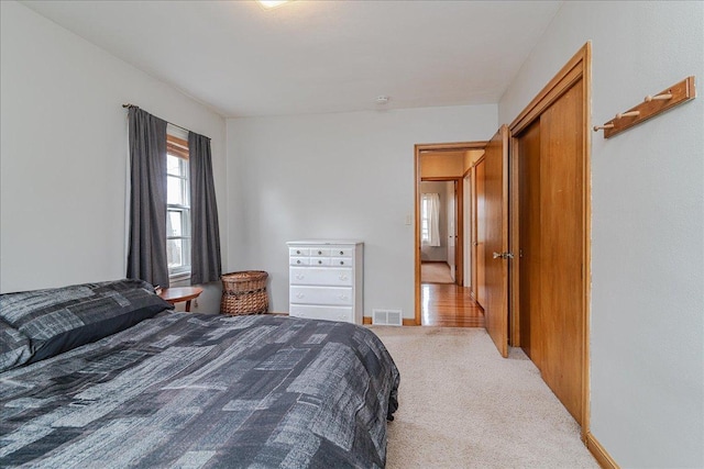 carpeted bedroom with baseboards and visible vents
