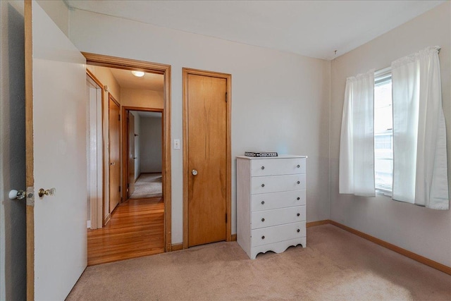 carpeted bedroom featuring baseboards