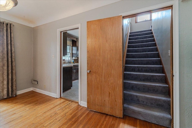 stairs with baseboards and wood finished floors