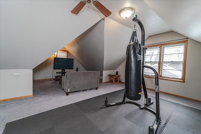 exercise room with a ceiling fan, baseboards, carpet, and lofted ceiling