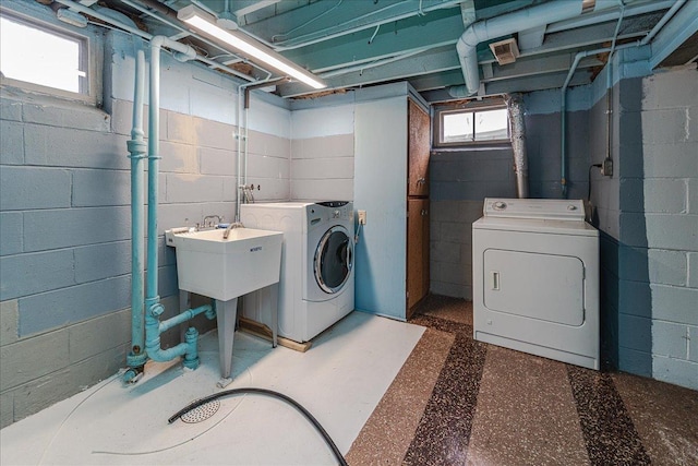 clothes washing area featuring laundry area and washing machine and clothes dryer