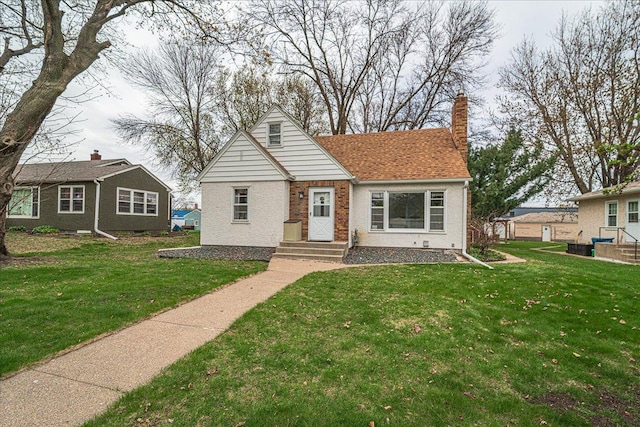 bungalow-style house with a chimney, brick siding, and a front yard
