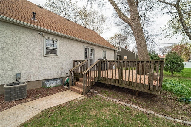 exterior space featuring a deck, central AC, a shingled roof, and stucco siding
