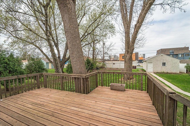 wooden terrace featuring a yard and an outdoor structure