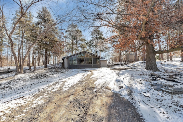 exterior space with a sunroom and driveway