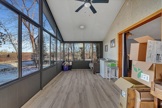 sunroom / solarium featuring plenty of natural light and ceiling fan
