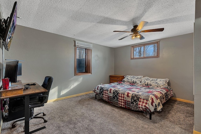 bedroom featuring carpet floors, a textured ceiling, and a ceiling fan