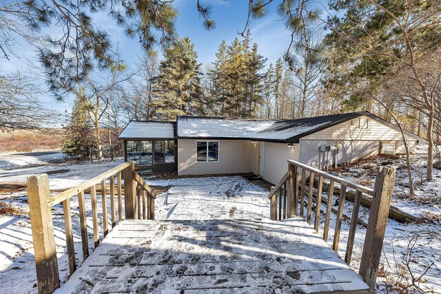 view of snow covered back of property