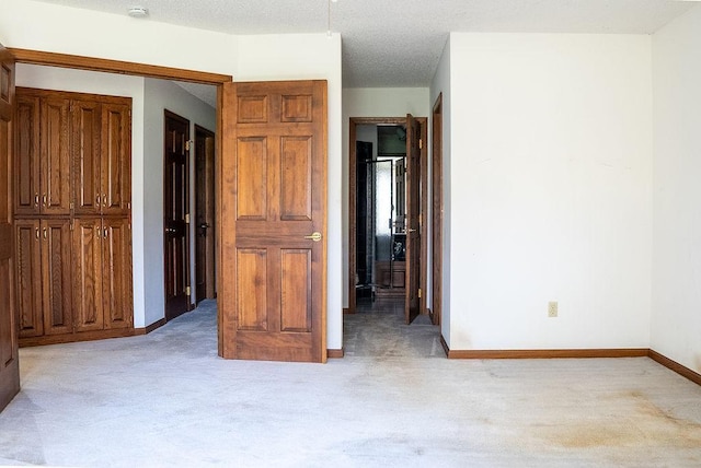 bedroom with baseboards and light colored carpet