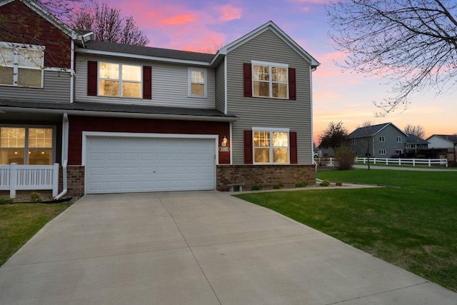 1893 13th St W, Hastings, MN 55033 - view of front of home featuring fence, an attached garage, brick siding, a front yard, and concrete driveway