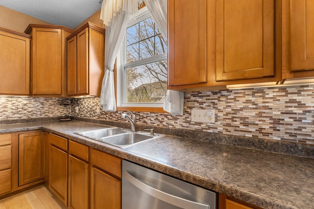 1893 13th St W, Hastings, MN 55033 - kitchen with brown cabinetry, dark countertops, dishwasher, a sink, and backsplash