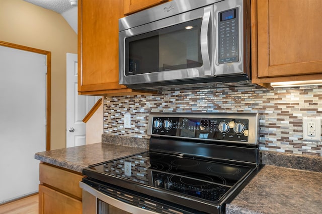 1893 13th St W, Hastings, MN 55033 - kitchen featuring dark countertops, tasteful backsplash, and stainless steel appliances