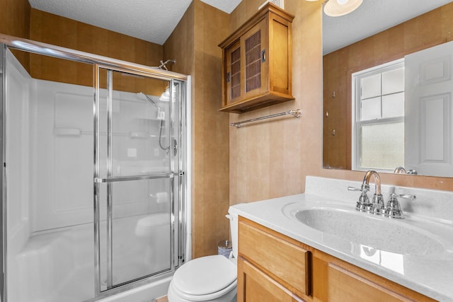 1893 13th St W, Hastings, MN 55033 - bathroom featuring toilet, a textured ceiling, a shower stall, and vanity
