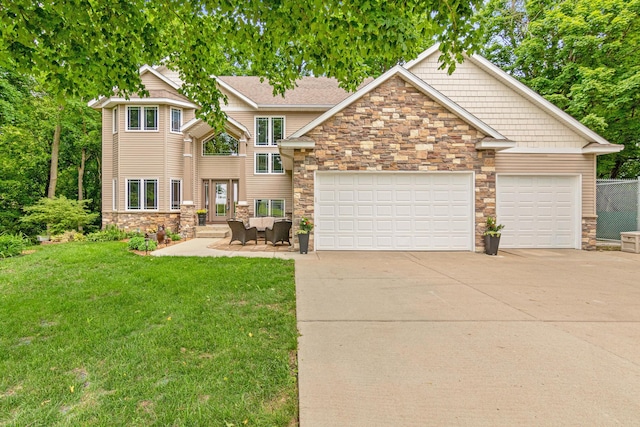 5450 Raven Point Rd, Prior Lake, MN 55372 - view of front of house featuring stone siding, concrete driveway, a front lawn, and an attached garage