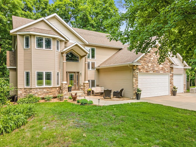 5450 Raven Point Rd, Prior Lake, MN 55372 - view of front of home featuring stone siding, outdoor lounge area, concrete driveway, and a front yard