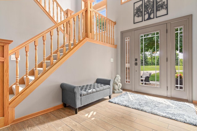 5450 Raven Point Rd, Prior Lake, MN 55372 - foyer featuring plenty of natural light, stairs, wood finished floors, and a towering ceiling