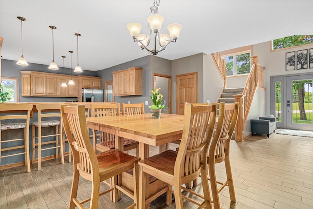5450 Raven Point Rd, Prior Lake, MN 55372 - dining space featuring stairs, a chandelier, and light wood finished floors