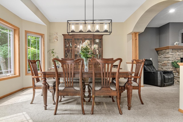 5450 Raven Point Rd, Prior Lake, MN 55372 - dining area with carpet, baseboards, arched walkways, and a chandelier