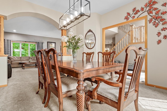 5450 Raven Point Rd, Prior Lake, MN 55372 - dining area with arched walkways, light carpet, baseboards, and stairway