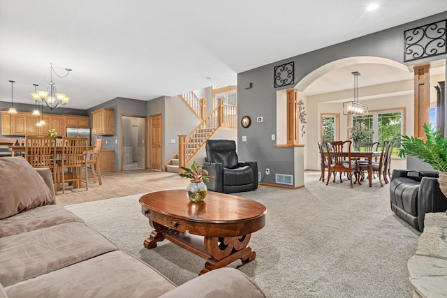 5450 Raven Point Rd, Prior Lake, MN 55372 - living area with arched walkways, stairway, a chandelier, baseboards, and recessed lighting