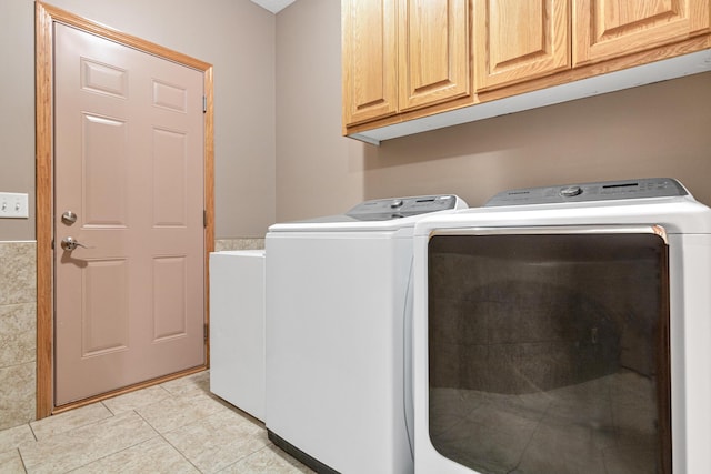 5450 Raven Point Rd, Prior Lake, MN 55372 - washroom with washing machine and dryer, cabinet space, and light tile patterned flooring