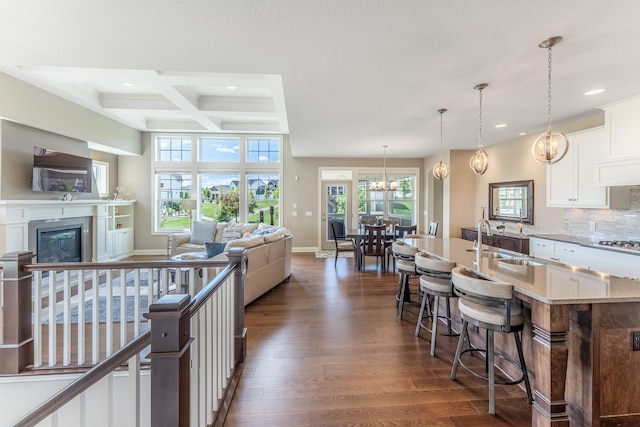 11328 Blazingstar Ln, Lake Elmo, MN 55042 - kitchen with a sink, recessed lighting, dark wood-style flooring, beamed ceiling, and a breakfast bar area