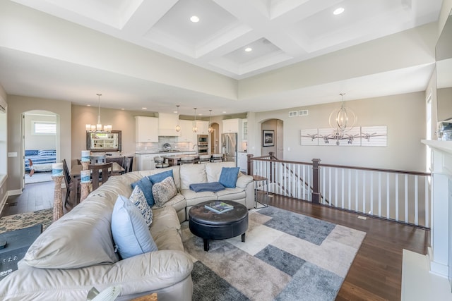 11328 Blazingstar Ln, Lake Elmo, MN 55042 - living area featuring a chandelier, arched walkways, wood finished floors, coffered ceiling, and beamed ceiling