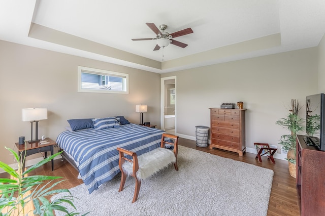 11328 Blazingstar Ln, Lake Elmo, MN 55042 - bedroom featuring a raised ceiling, wood finished floors, and baseboards