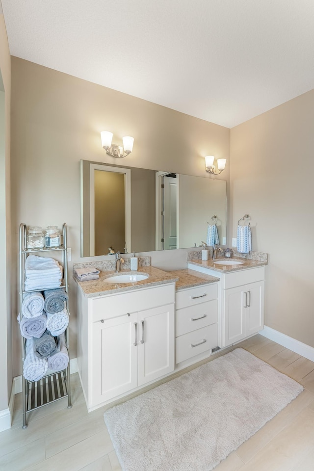 11328 Blazingstar Ln, Lake Elmo, MN 55042 - full bathroom with double vanity and baseboards