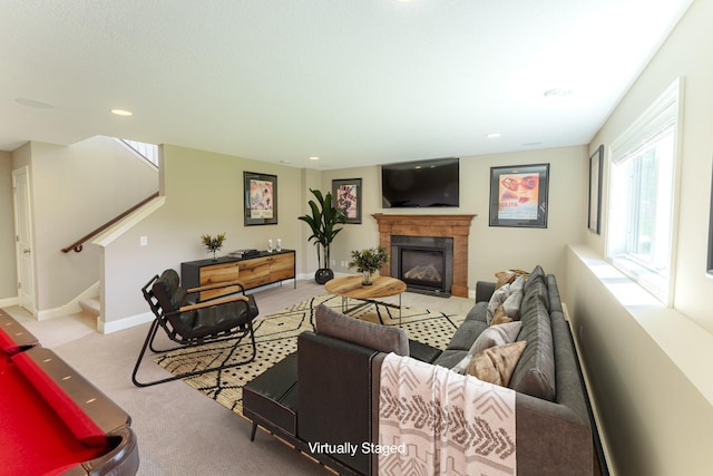 11328 Blazingstar Ln, Lake Elmo, MN 55042 - carpeted living room featuring a glass covered fireplace, stairway, recessed lighting, and baseboards