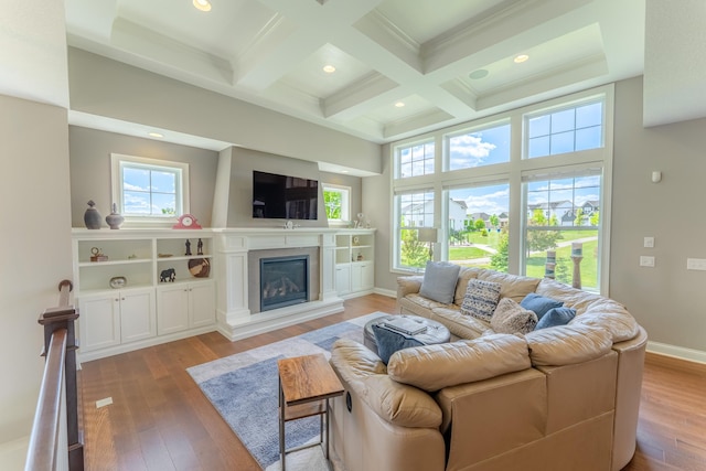 11328 Blazingstar Ln, Lake Elmo, MN 55042 - living room featuring plenty of natural light, beamed ceiling, hardwood / wood-style flooring, a glass covered fireplace, and coffered ceiling