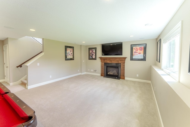 11328 Blazingstar Ln, Lake Elmo, MN 55042 - unfurnished living room with light colored carpet, a fireplace with flush hearth, baseboards, stairway, and recessed lighting