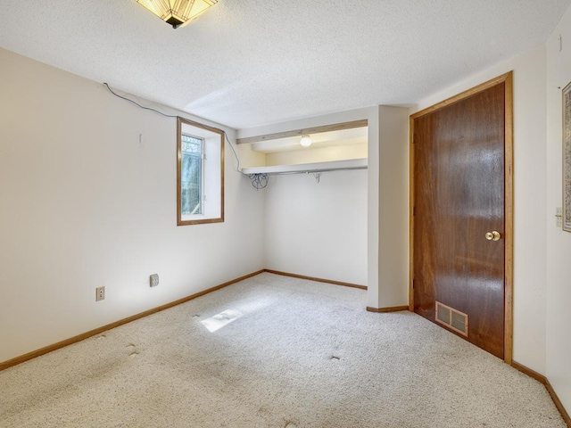 unfurnished bedroom with baseboards, visible vents, and carpet