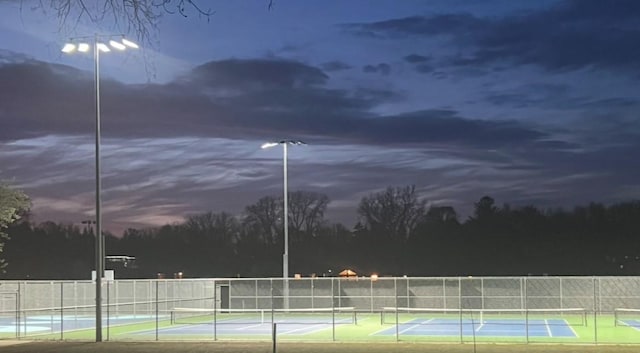 view of tennis court featuring fence