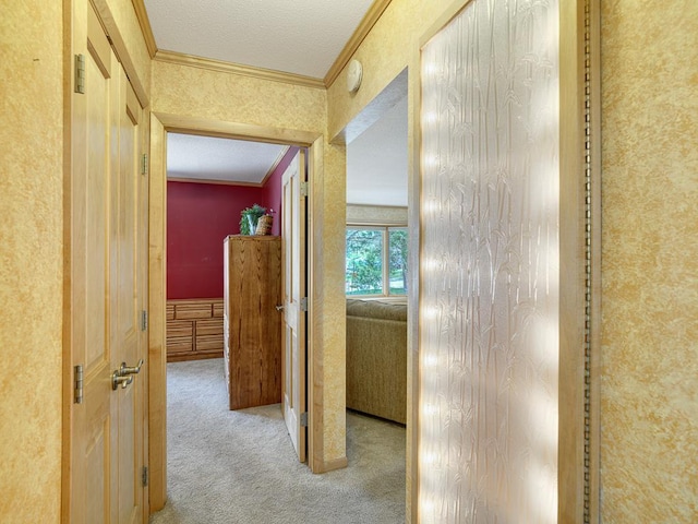 corridor with carpet, a textured ceiling, and ornamental molding