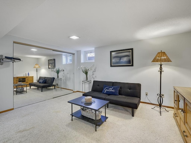 carpeted living area featuring baseboards