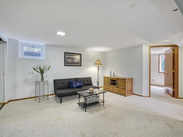 carpeted living area with baseboards and visible vents