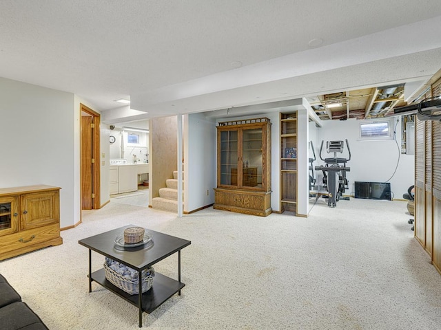 living area featuring stairs, washer and dryer, and carpet floors