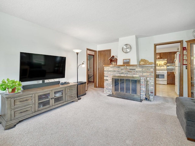 living room with carpet flooring, a fireplace, and a textured ceiling