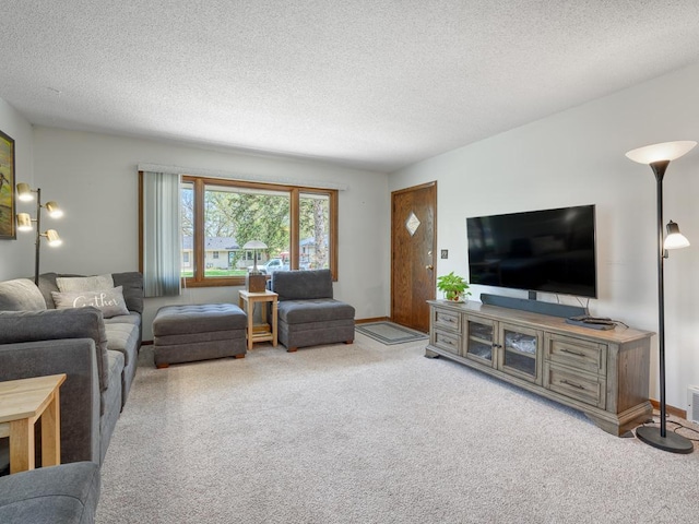 living area with carpet flooring, visible vents, and a textured ceiling