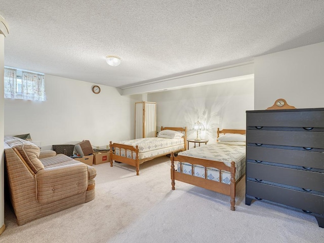 bedroom featuring a textured ceiling and carpet