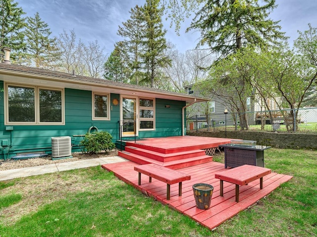 wooden terrace featuring a yard, fence, and central AC