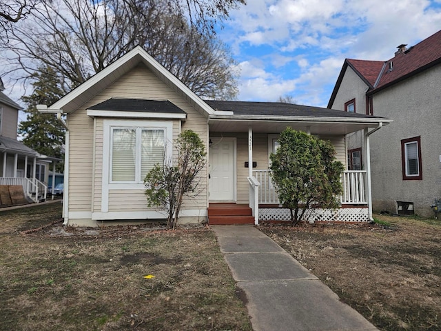 bungalow-style house with a shingled roof and covered porch