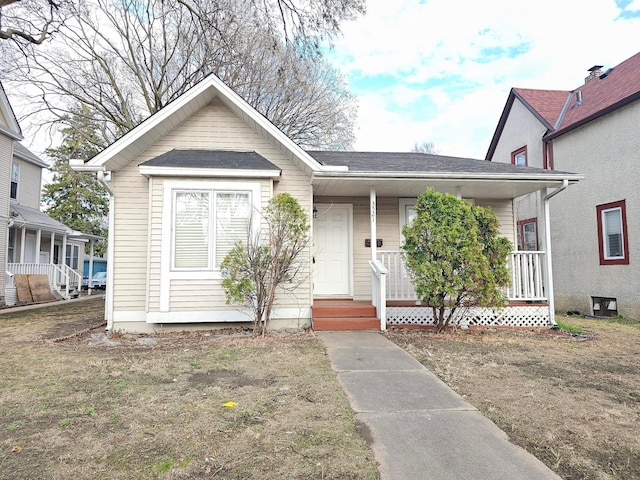 bungalow with a shingled roof and covered porch
