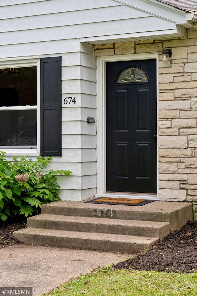 674 Wheelock Pkwy W, Saint Paul, MN 55117 - doorway to property with stone siding