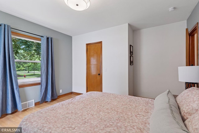 674 Wheelock Pkwy W, Saint Paul, MN 55117 - bedroom featuring light wood-type flooring and baseboards
